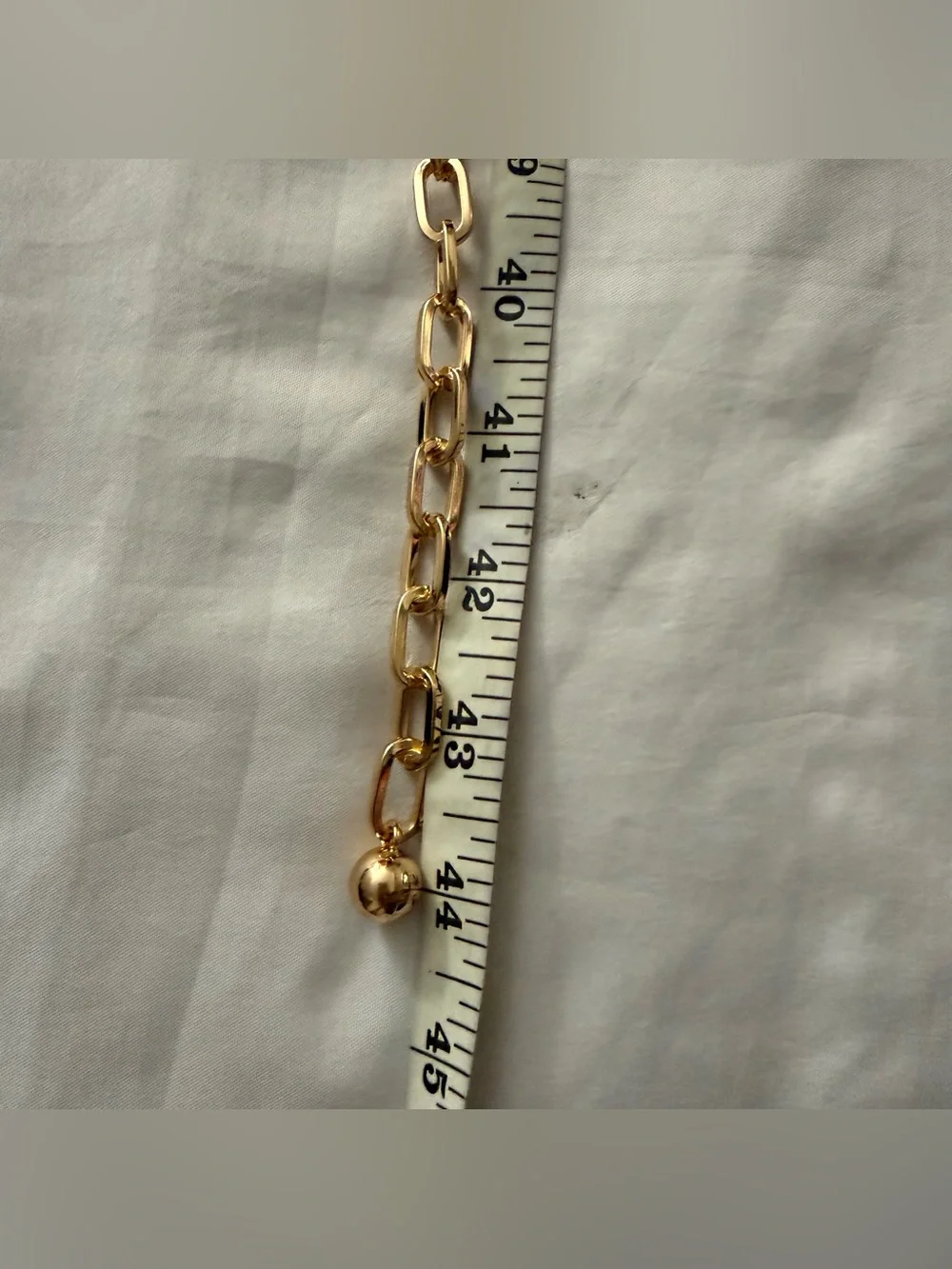 Gold tone metallic charms skinny chain belt
